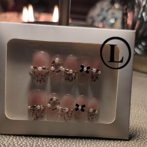 Stylish Pink Press-On Nails with Black Cross Design